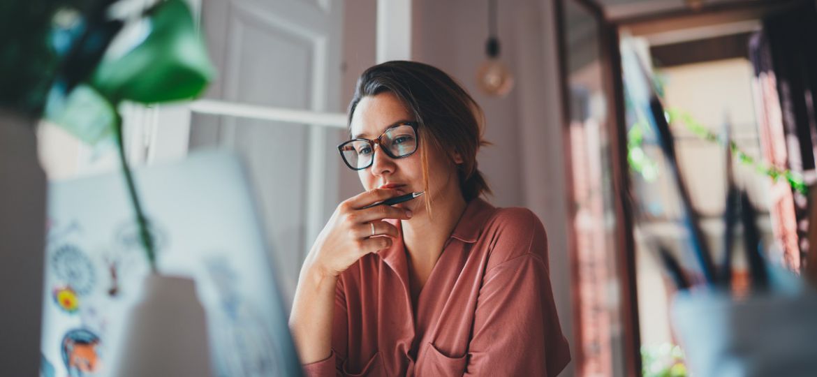 Young,Businesswoman,Thinking,About,Something,While,Sitting,Front,Open,Portable